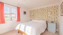This double bedroom has windows looking over the village green and garden.