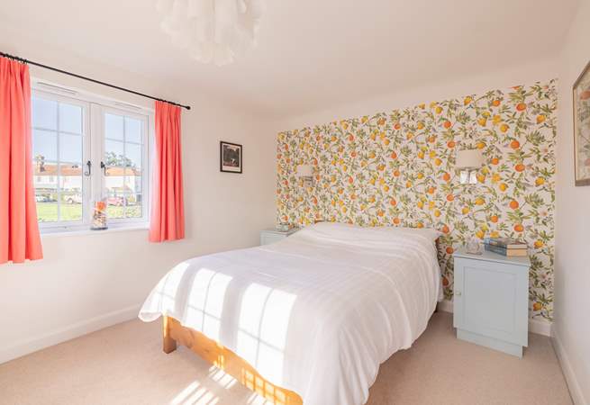 This double bedroom has windows looking over the village green and garden.