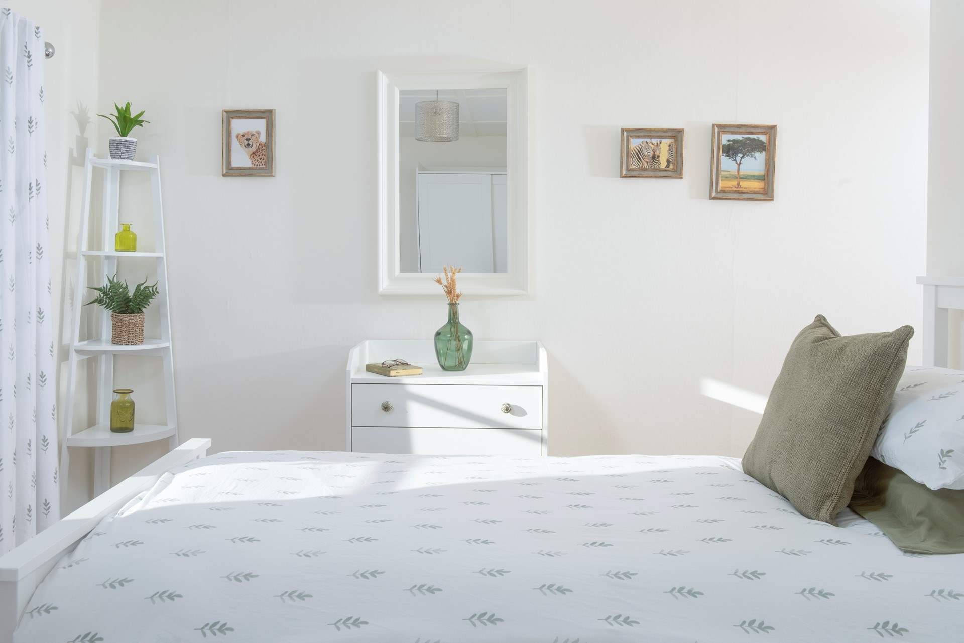 A serene twin bedroom bathed in light and gentle tones.