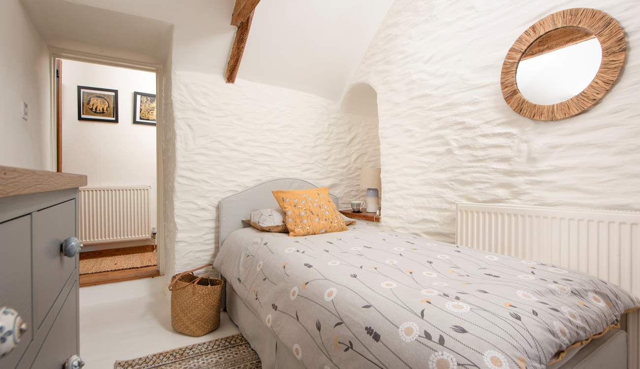 Pretty linens dress this inviting single bed.