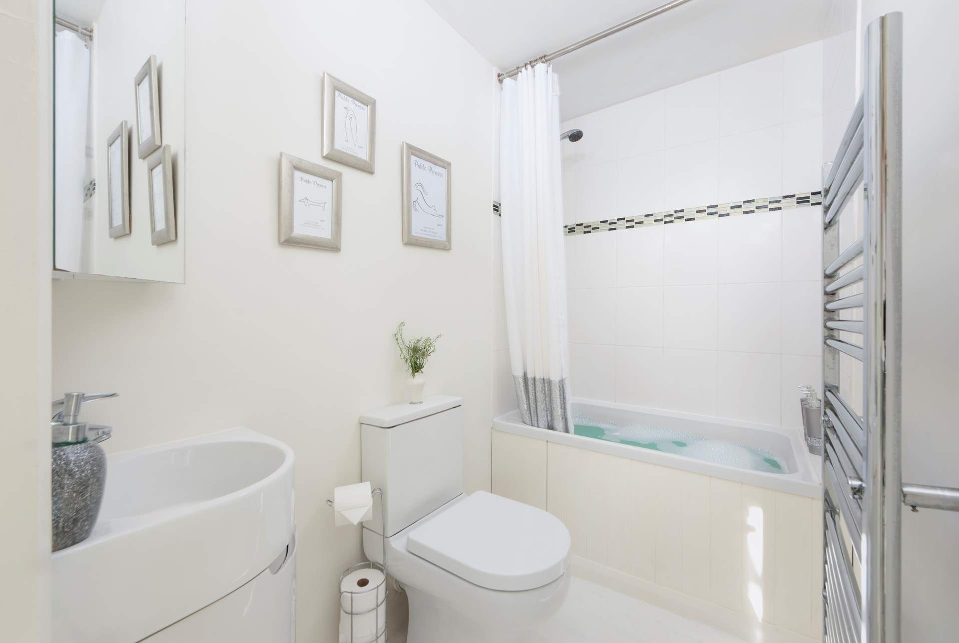 The en suite has a delightful small bath and shower.