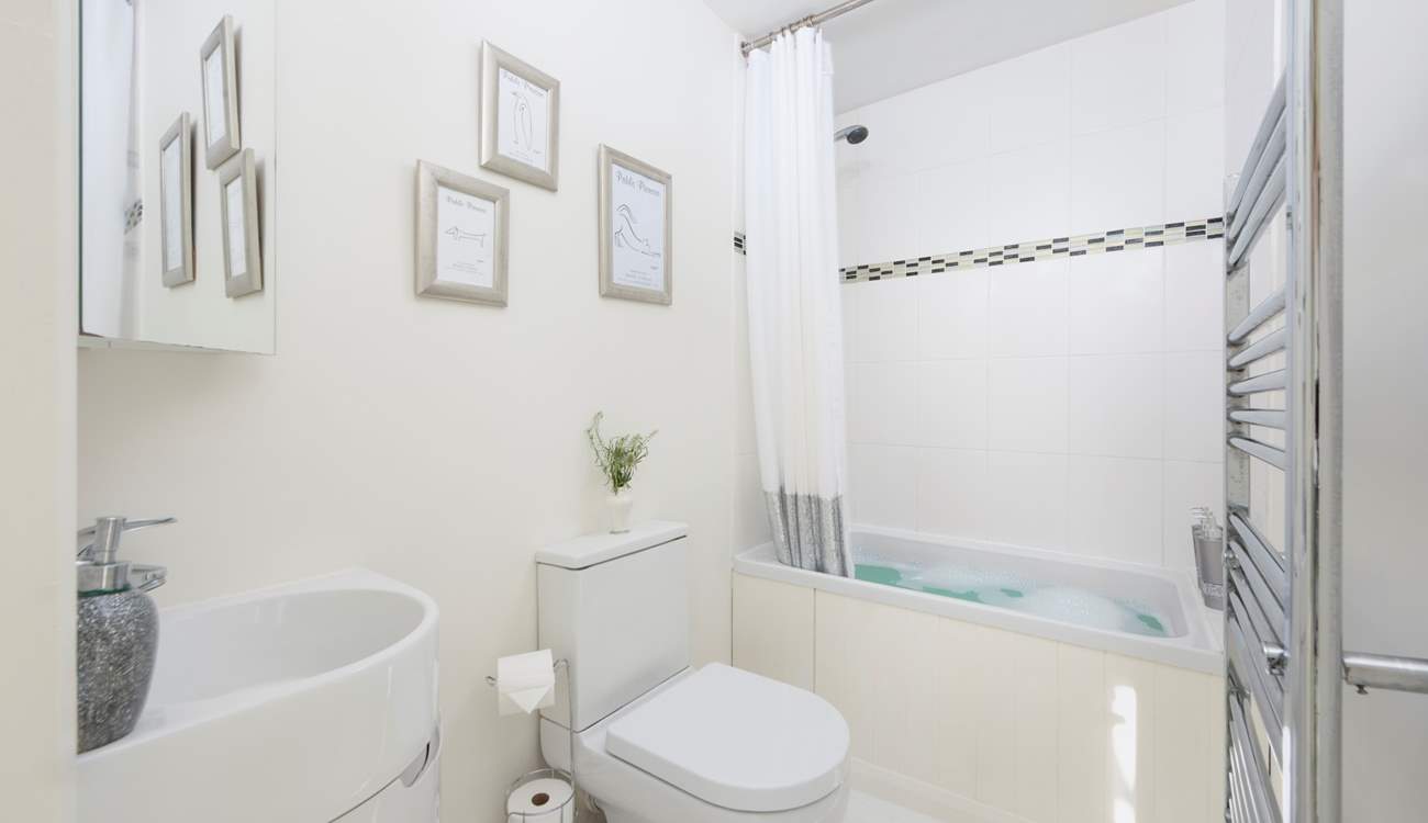 The en suite has a delightful small bath and shower.