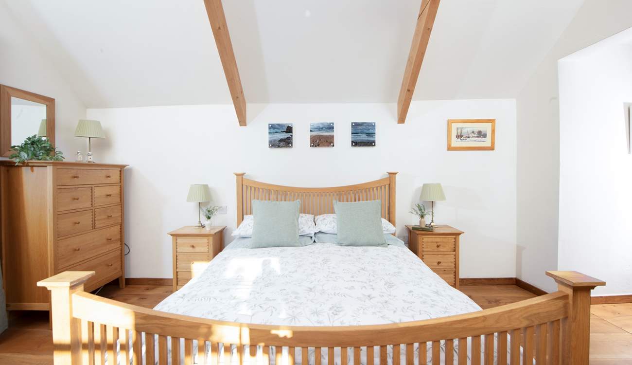 Snuggle under the covers of the king-size bed.