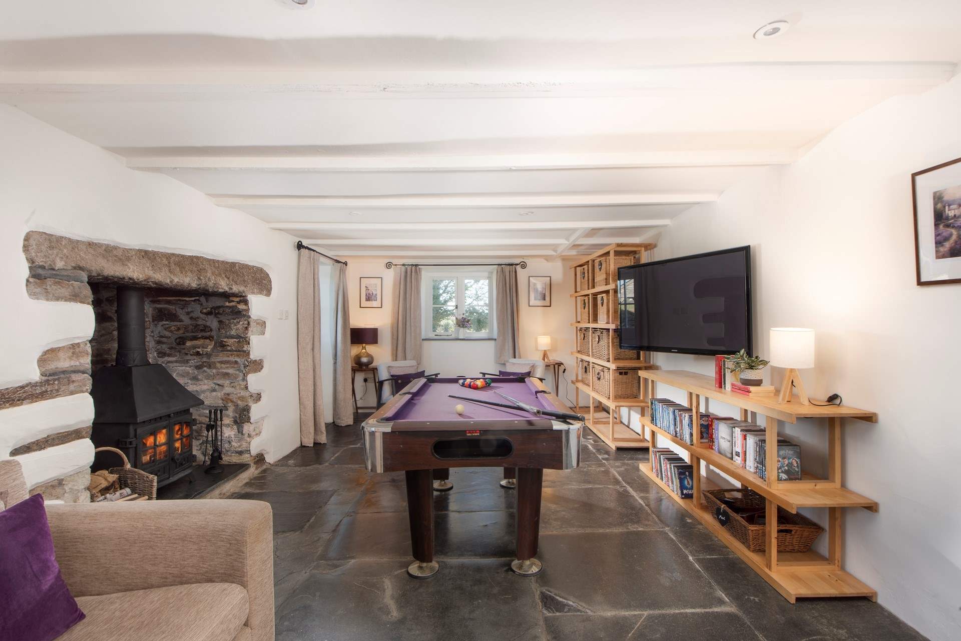 Featuring a large-screen TV and pool table, the games-room/snug provides an additional space for laid-back relaxation and entertainment.