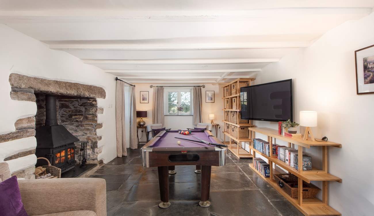 Featuring a large-screen TV and pool table, the games-room/snug provides an additional space for laid-back relaxation and entertainment.