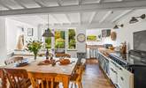 The open plan kitchen and dining-area is a bright and airy space, perfect for enjoying any meal. - Thumbnail Image