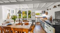 The open plan kitchen and dining-area is a bright and airy space, perfect for enjoying any meal.