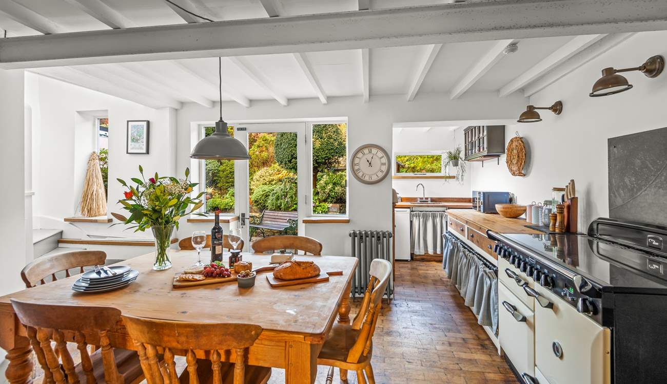 The open plan kitchen and dining-area is a bright and airy space, perfect for enjoying any meal.