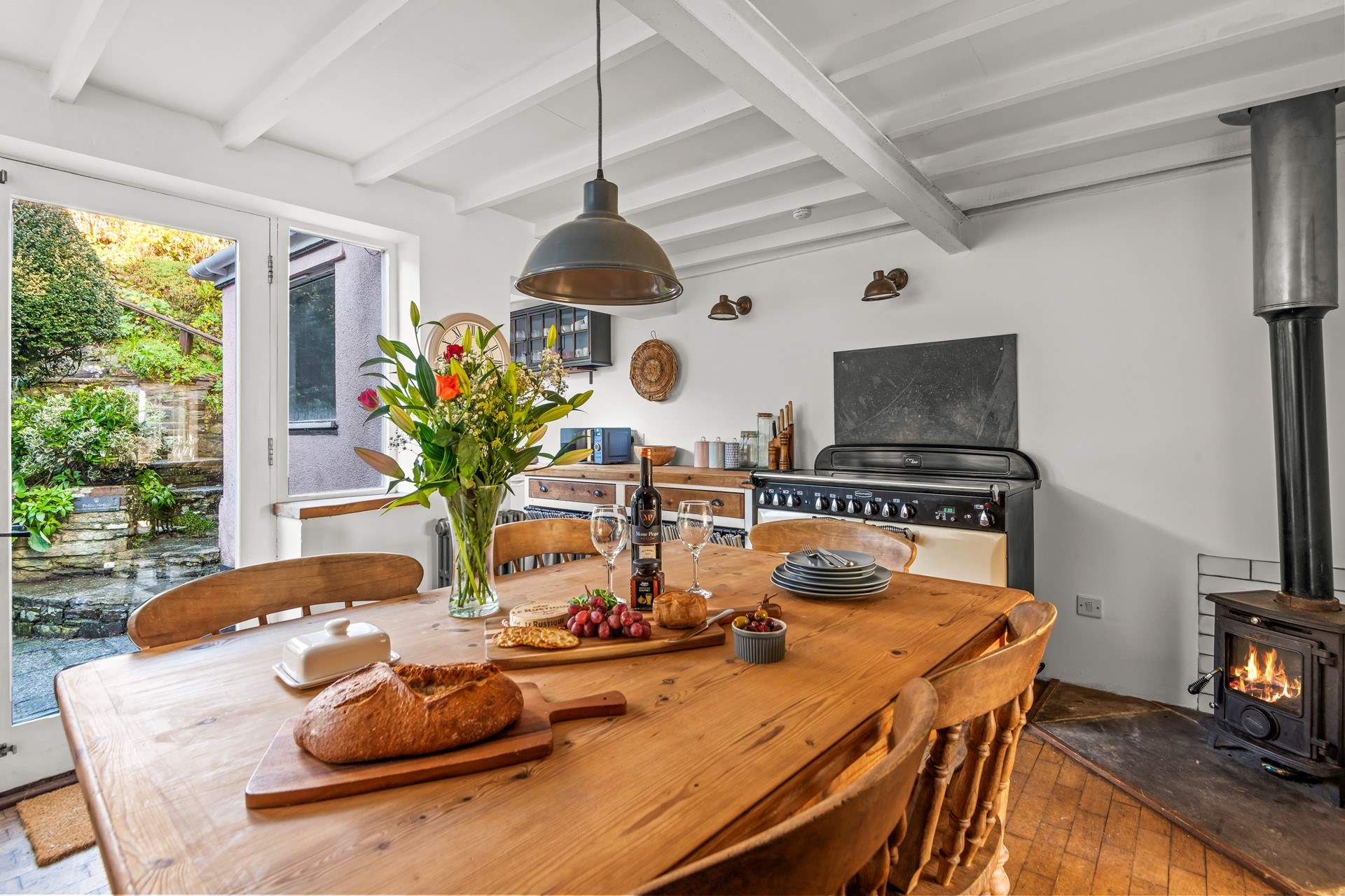 The kitchen and dining area opens up into the courtyard, perfect for enjoying those summer evenings. Likewise, the glowing wood-burner makes dining in this area a pleasure in the cooler months.