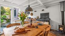 The kitchen and dining area opens up into the courtyard, perfect for enjoying those summer evenings. Likewise, the glowing wood-burner makes dining in this area a pleasure in the cooler months.