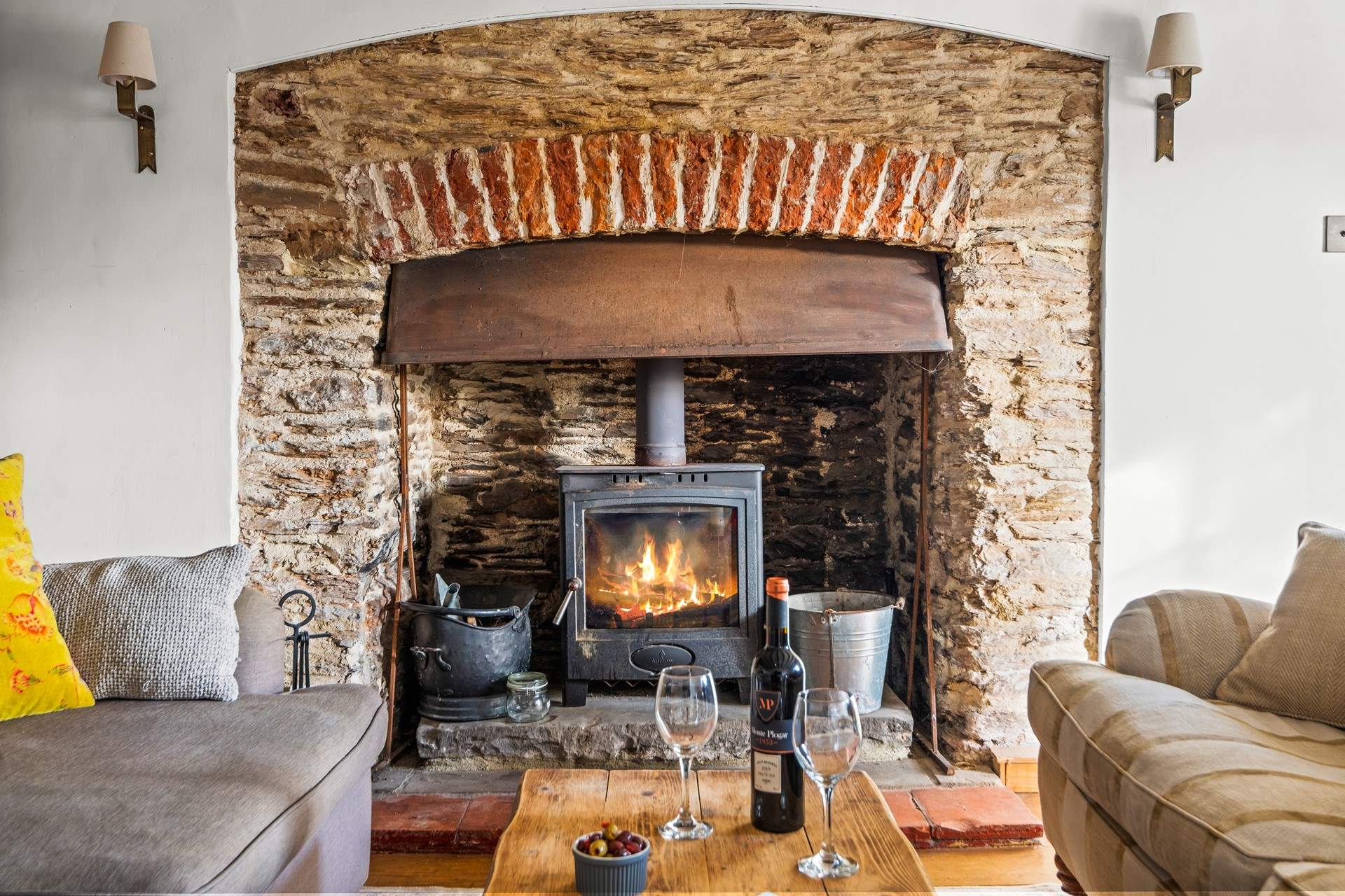 The glowing wood-burner is a fabulous addition to this welcoming sitting-room.