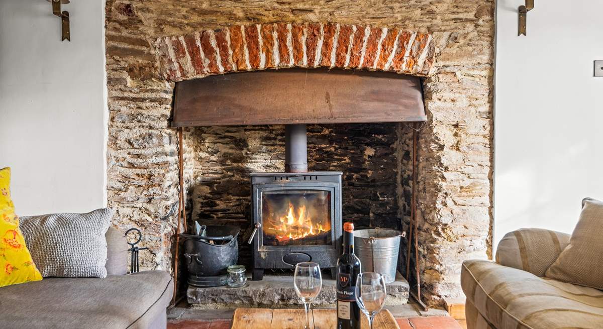 The glowing wood-burner is a fabulous addition to this welcoming sitting-room.