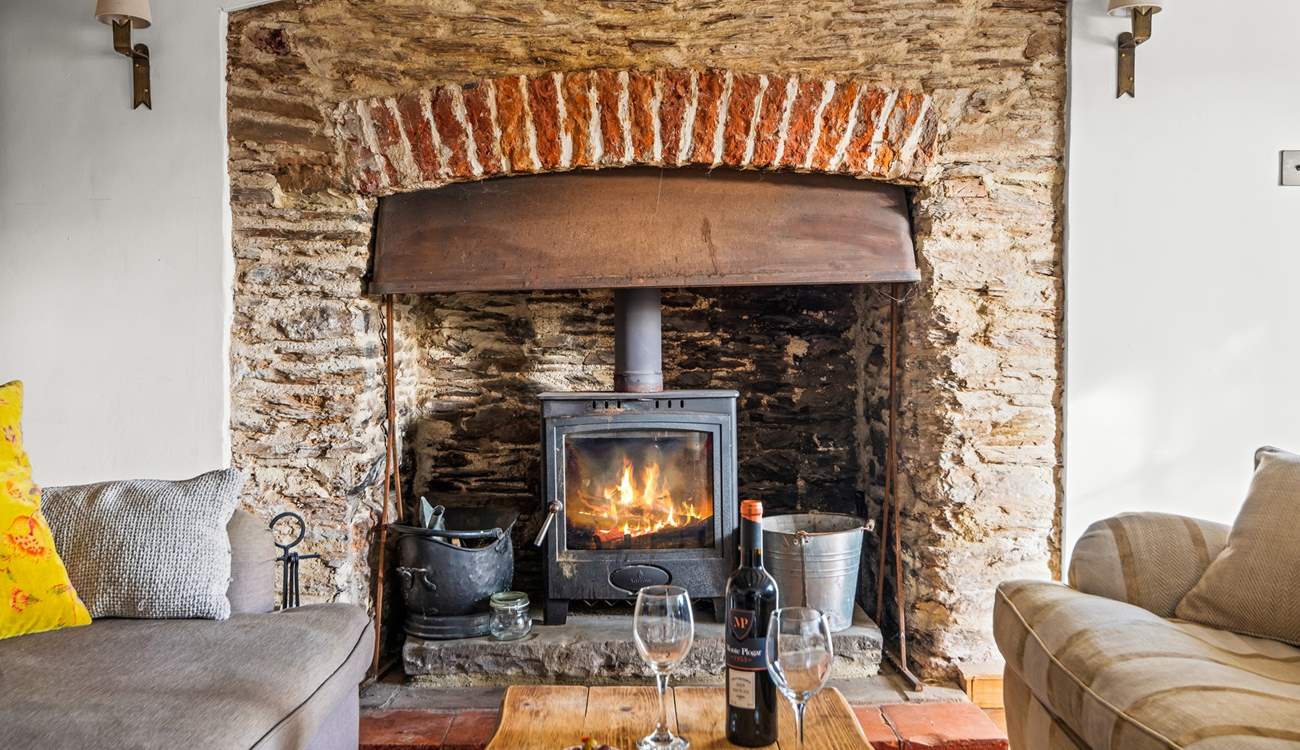The glowing wood-burner is a fabulous addition to this welcoming sitting-room.