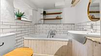 The ground floor bathroom is located conveniently through a small hallway via the sitting-room.