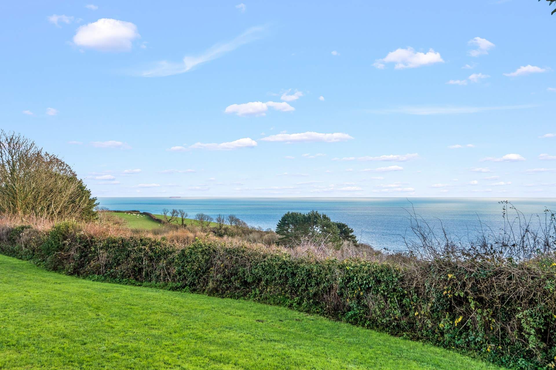 Magnificent countryside and sea views can be enjoyed from the top garden seating area.