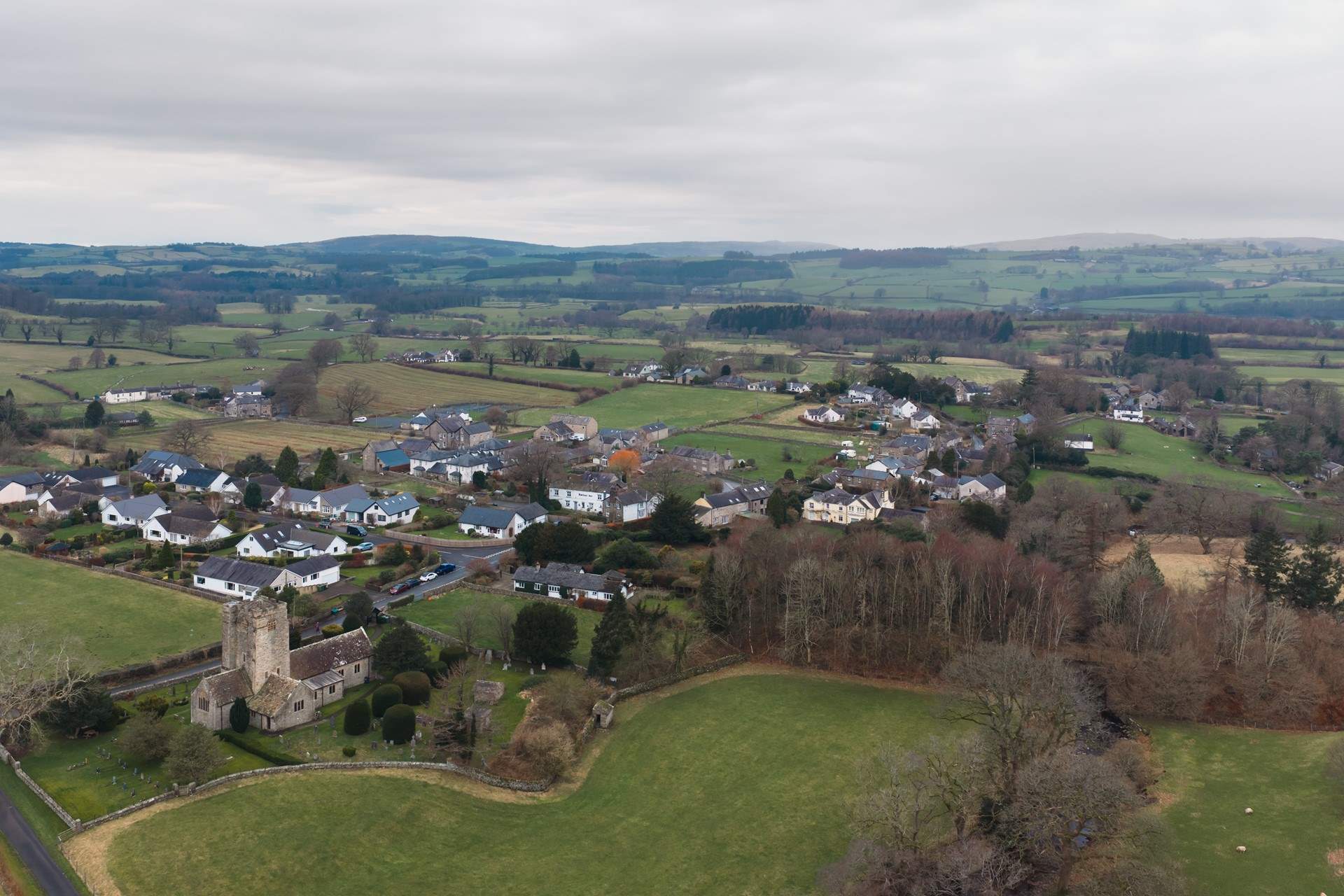 Barbon from the air with the local church and the rolling hills and fields beyond.