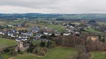 Barbon from the air with the local church and the rolling hills and fields beyond.