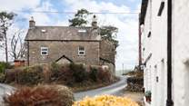 The cottage is built of traditional stone and sits atop the village. 