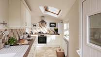The sleek and contemporary kitchen has all the mod cons you need. 