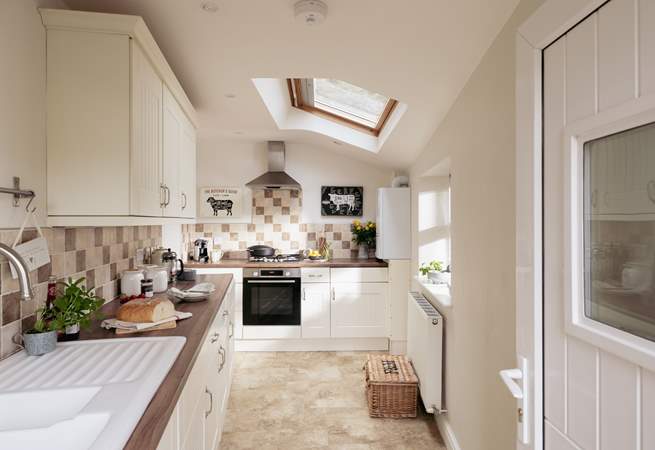 The sleek and contemporary kitchen has all the mod cons you need. 