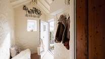 The entrance hall is a perfect place for coats, boots and a picnic basket.