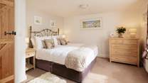The king-size bedroom on the first floor welcomes you in for a great night's sleep.