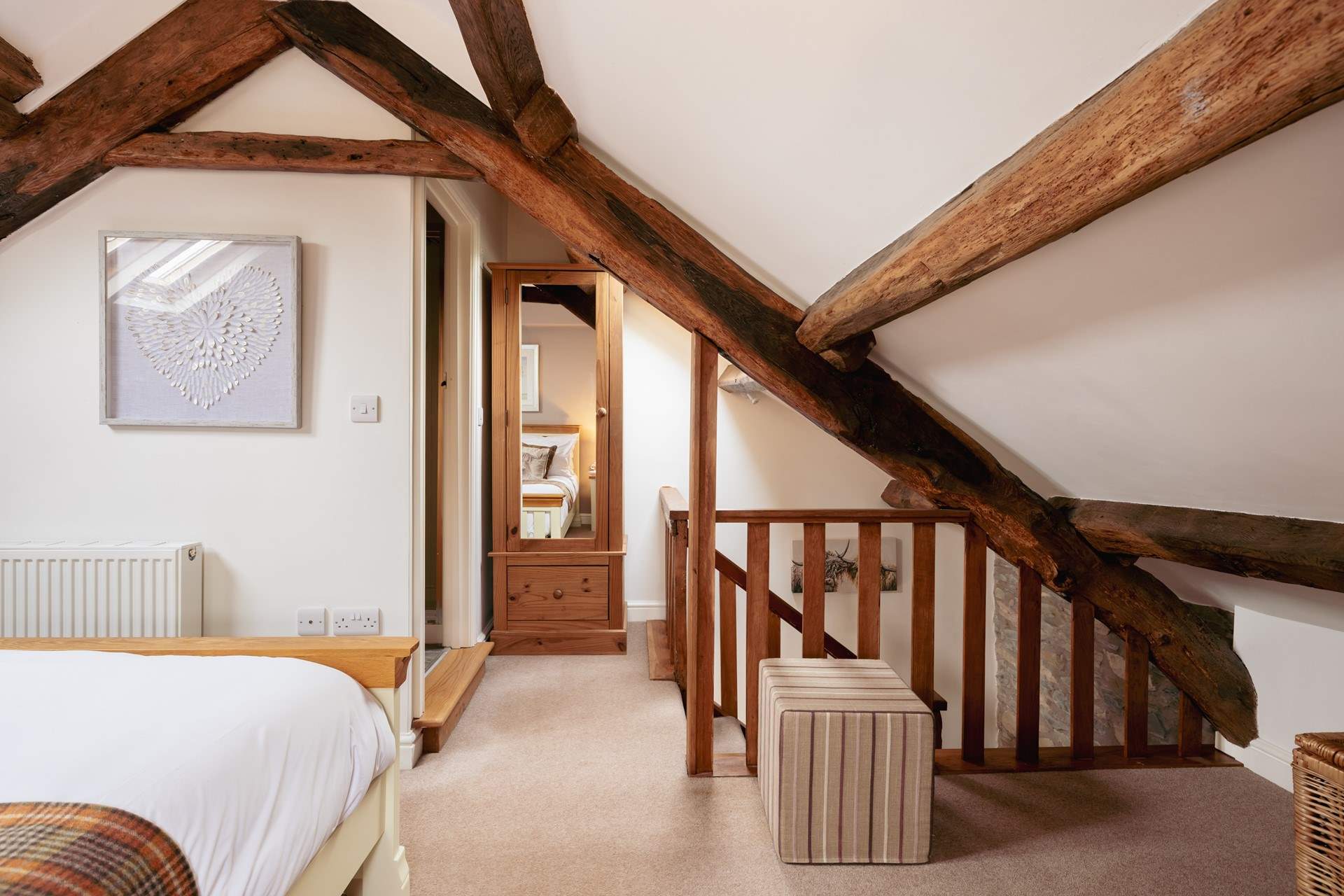 The original beams really frame the bedroom.