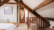 The original beams really frame the bedroom.