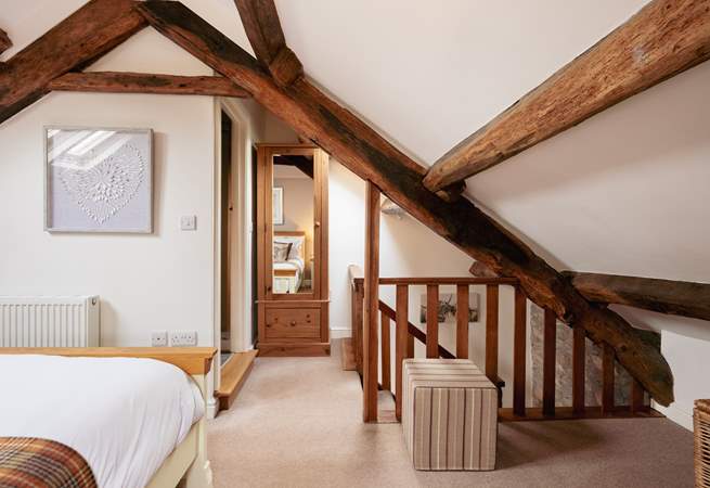 The original beams really frame the bedroom.