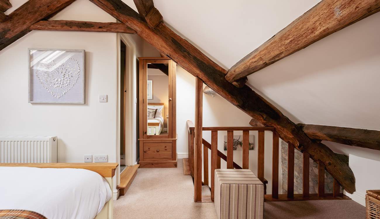The original beams really frame the bedroom.