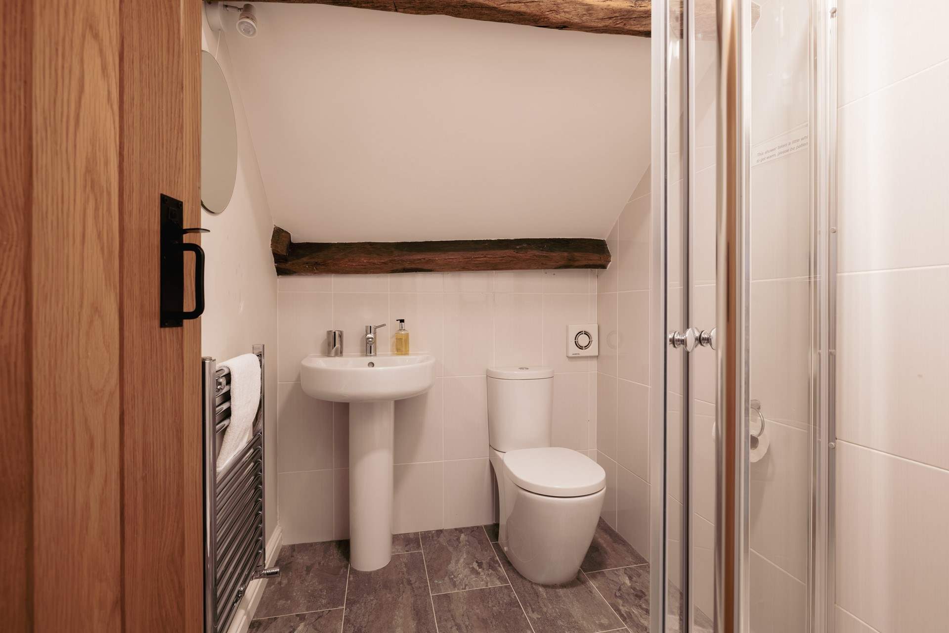 The en suite shower-room with lovely beams, the ceiling does slope and there is a step into this room so please take care.
