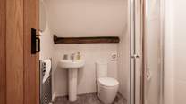 The en suite shower-room with lovely beams, the ceiling does slope and there is a step into this room so please take care.