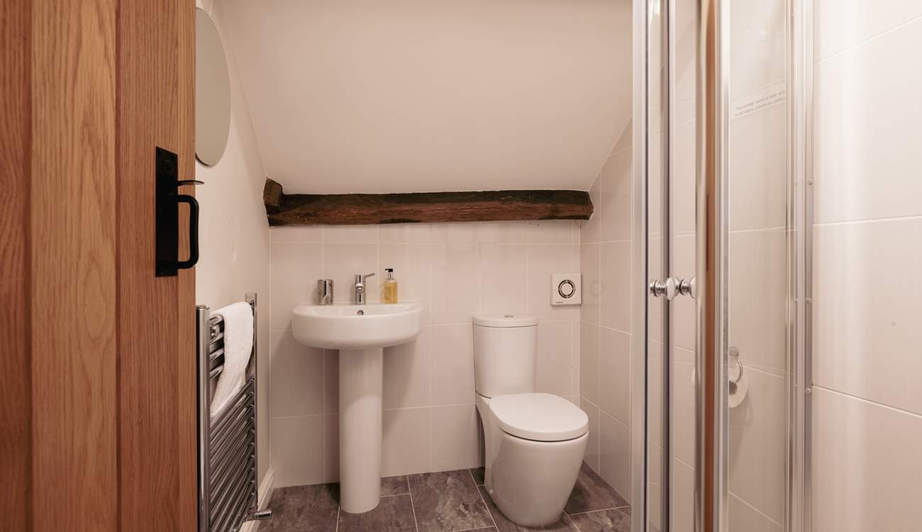 The en suite shower-room with lovely beams, the ceiling does slope and there is a step into this room so please take care.