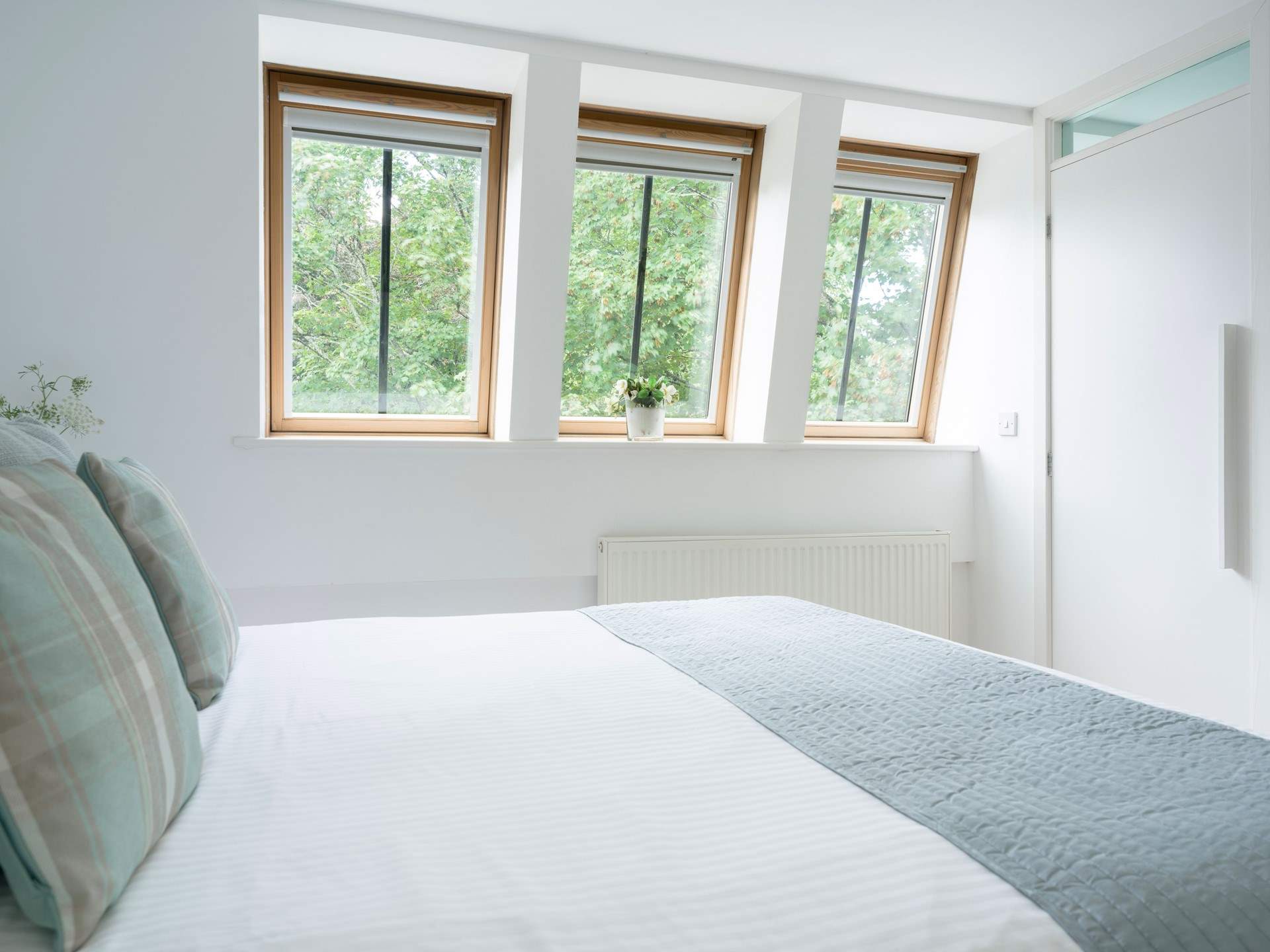 Set at the back of the house, the bedroom enjoys views of the river.