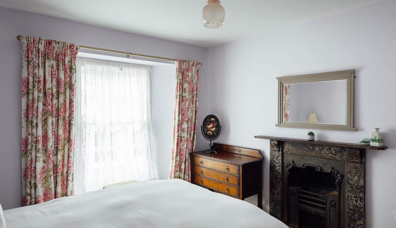 Original, gorgeous ornate fireplace in the king-size room located to the front of the house. 