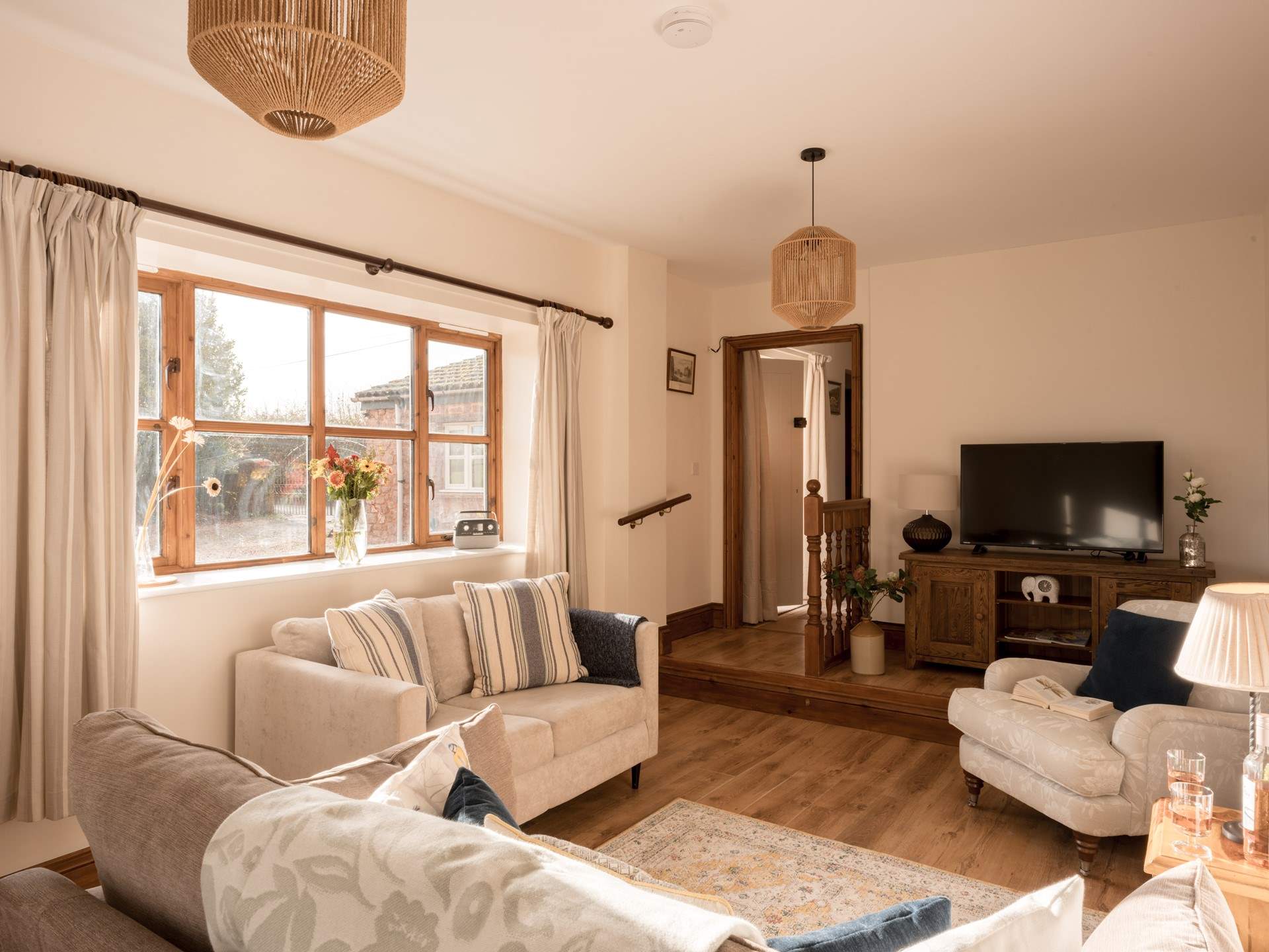 The perfect social layout in the lovely light sitting-room. A ramp is available for easier access down the step in from the hallway.