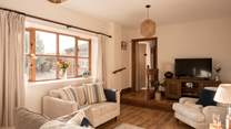 The perfect social layout in the lovely light sitting-room. A ramp is available for easier access down the step in from the hallway.