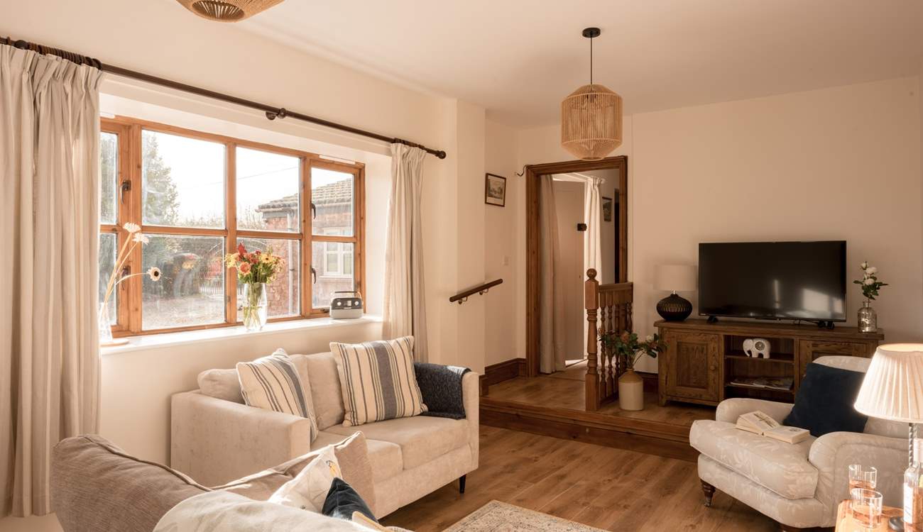 The perfect social layout in the lovely light sitting-room. A ramp is available for easier access down the step in from the hallway.
