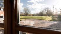 Views out from the sitting-room over the sweeping lawns of the main house.