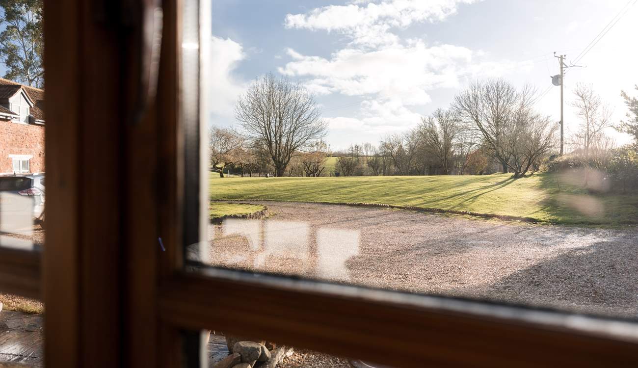 Views out from the sitting-room over the sweeping lawns of the main house.