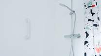 A wonderful rainfall shower and deep bath await to ease any achy legs after a day exploring.