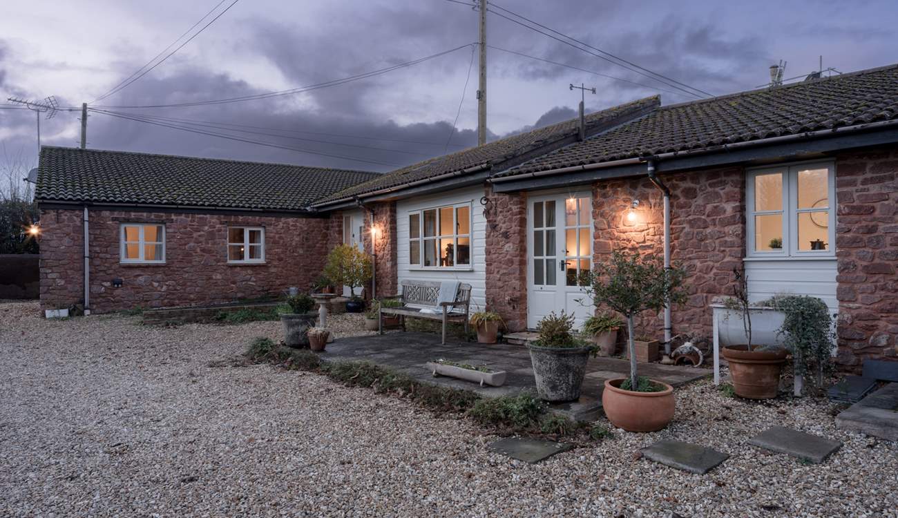 A wonderful private patio runs across more of the property with lovely views over the lawns of the main house. Outdoor chairs and a table are in situ during the warmer months. Note that this area will soon have some privacy screening added.