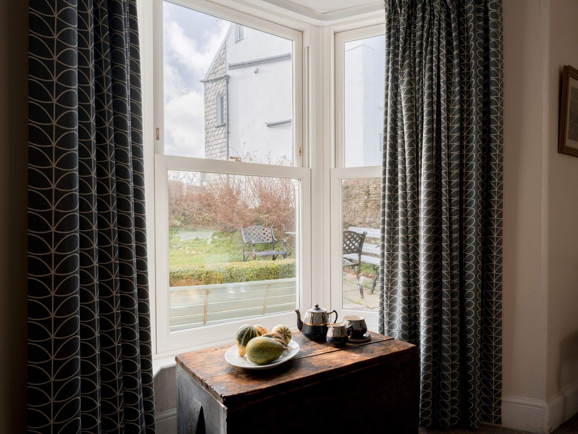 The house is set back from the village with a gated front garden.