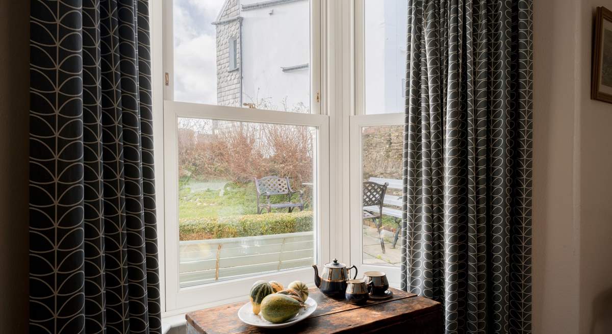 The house is set back from the village with a gated front garden.