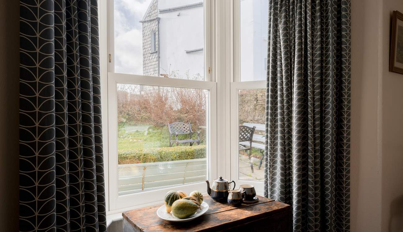 The house is set back from the village with a gated front garden.