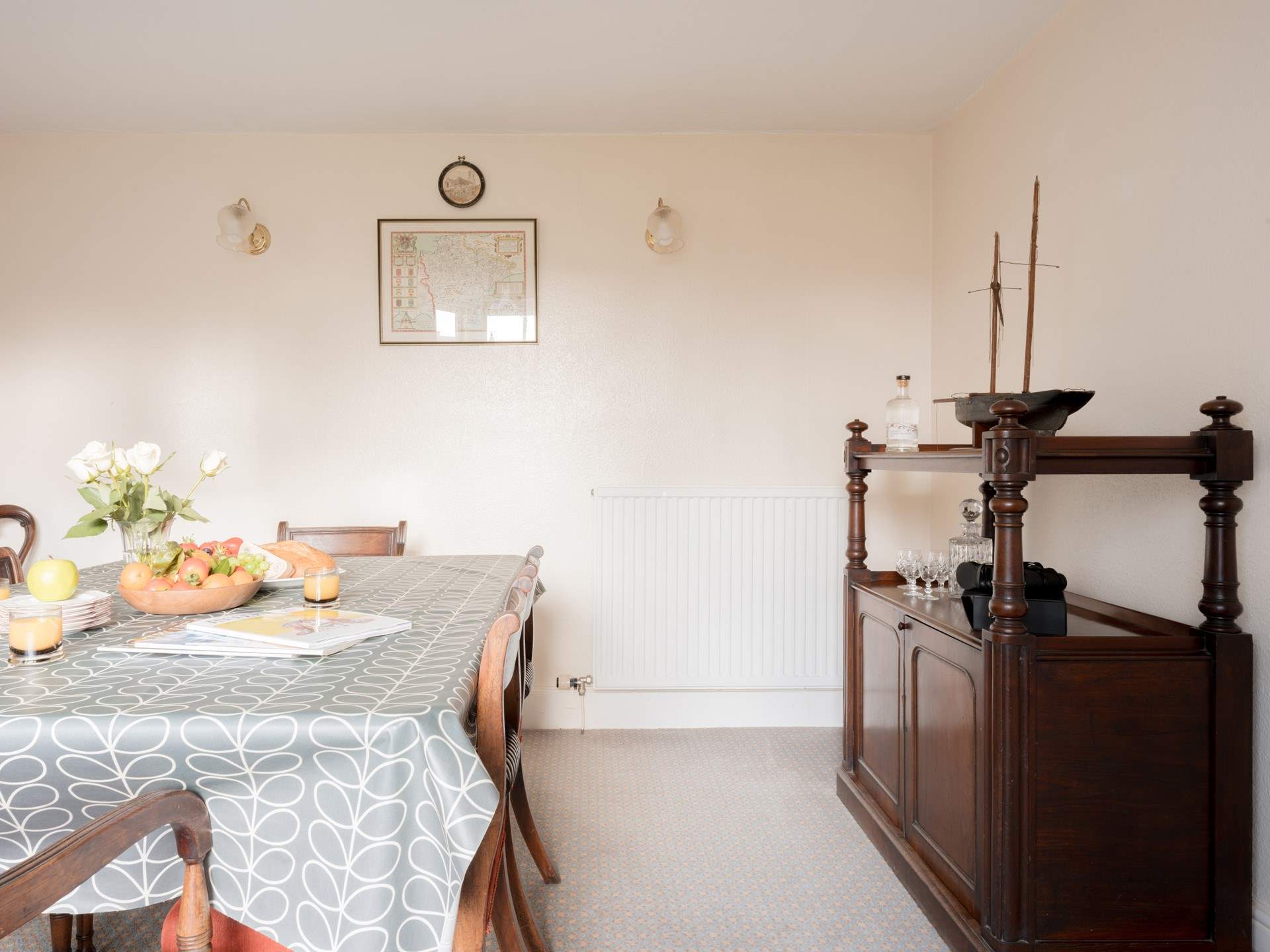 The large dining-table awaits the chatter of a family feast.