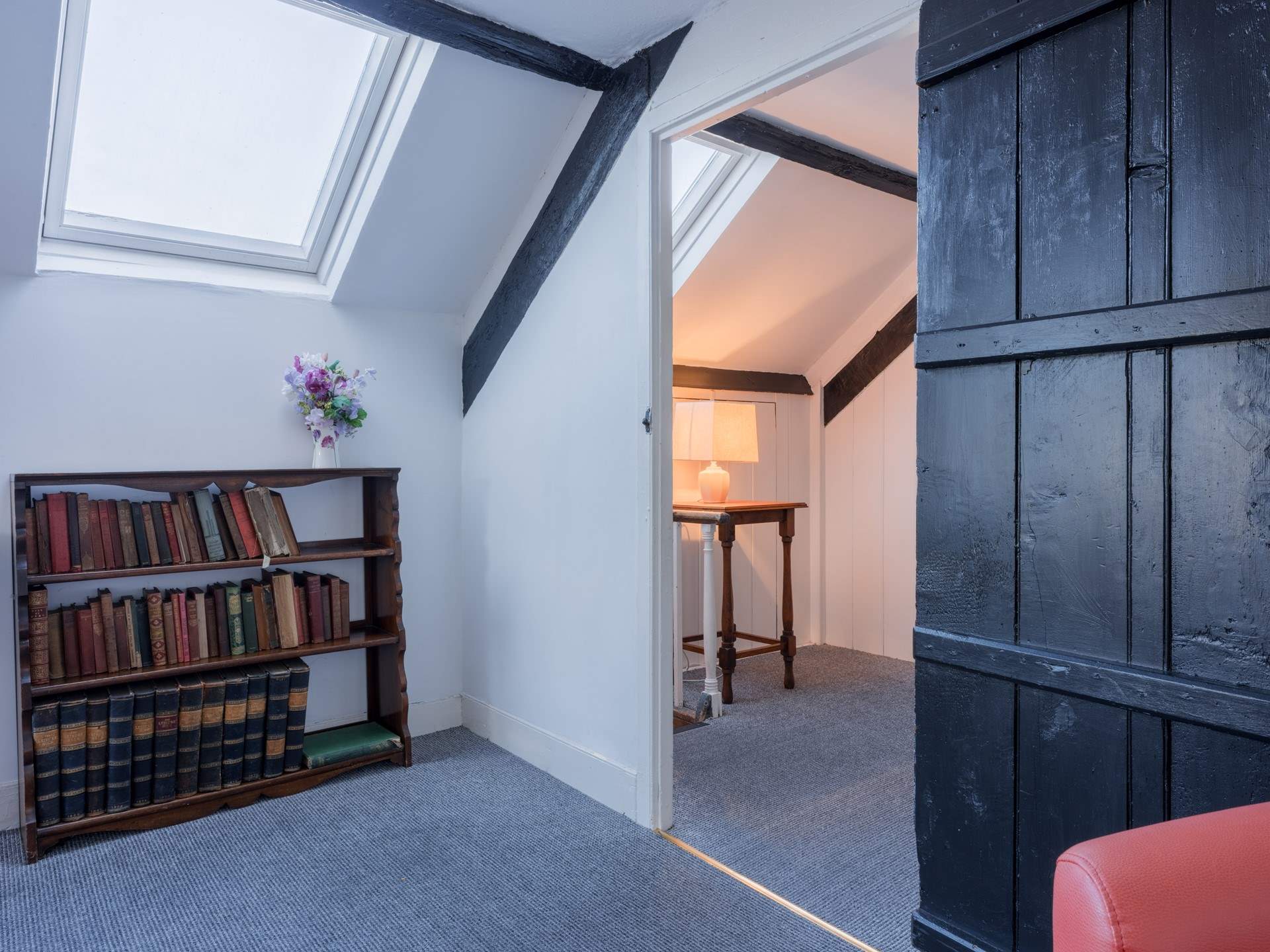 Climb the steep stairs up to the converted attic rooms.
