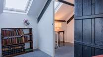 Climb the steep stairs up to the converted attic rooms.