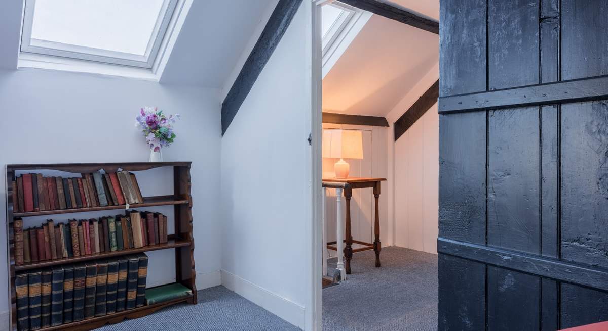 Climb the steep stairs up to the converted attic rooms.