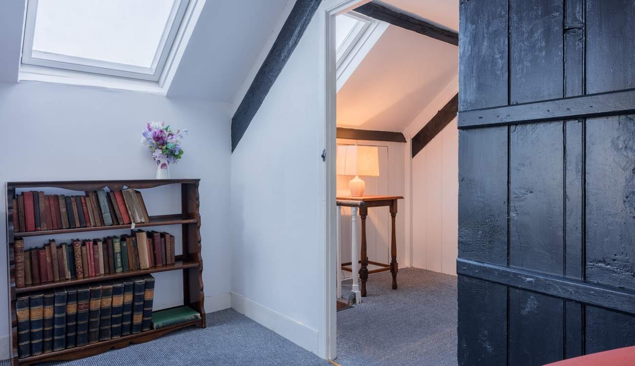 Climb the steep stairs up to the converted attic rooms.